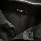 streetcave.eu Burberry Black Label Poloshirt in Schwarz und Grau mit Markenlogo am Kragen und gravierten Knöpfen